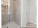 The modern shower is fully tiled with a glass door and a built-in shelf at 1503 Autumn Banks Way # 2P, High Shoals, NC 28077