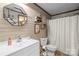 Bathroom features white vanity, toilet, and shower/tub with wood-like wall accents at 1691 Hopewell Church Rd, Catawba, NC 28609