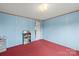 Comfortable bedroom with blue walls and red carpet perfect for a relaxing retreat at 1691 Hopewell Church Rd, Catawba, NC 28609