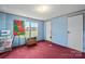 Bright bedroom with blue walls, a large window, and red carpet creating a cozy atmosphere at 1691 Hopewell Church Rd, Catawba, NC 28609