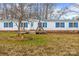 Charming single-story home featuring a blue metal roof and blue shutters enhancing its curb appeal at 1691 Hopewell Church Rd, Catawba, NC 28609