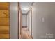 Hallway with neutral paint, wood-look flooring, and traditional molding at 1691 Hopewell Church Rd, Catawba, NC 28609
