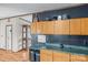 Kitchen featuring wood cabinetry, dark accent wall, and laminate countertops at 1691 Hopewell Church Rd, Catawba, NC 28609