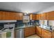 Galley kitchen with wood cabinets, stainless steel appliances and laminate countertops at 1691 Hopewell Church Rd, Catawba, NC 28609