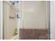 Enclosed shower stall with mounted shower head and wall shelving for storage at 1691 Hopewell Church Rd, Catawba, NC 28609
