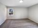 Spacious bedroom with neutral walls, plush carpeting, and a large window at 1830 Windy Rush Ln, Gastonia, NC 28054