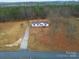Expansive aerial view of a one-story home on a large lot surrounded by lush greenery and scenic landscapes at 1912 Beach Ln, Heath Springs, SC 29058