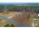 Aerial view of home with lush surrounding forest and large front yard at 1912 Beach Ln, Heath Springs, SC 29058