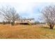The large, grassy backyard features a deck, stairs, and mature trees at 1912 Beach Ln, Heath Springs, SC 29058