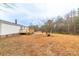 The large backyard features a deck, stairs, and mature trees at 1912 Beach Ln, Heath Springs, SC 29058
