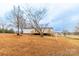 The large backyard features a deck, stairs, mature trees, and a firepit at 1912 Beach Ln, Heath Springs, SC 29058
