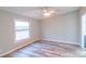 Bright bedroom with a ceiling fan, a window, and wood-look flooring at 1912 Beach Ln, Heath Springs, SC 29058