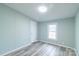 Bedroom with light walls, a window, simple closet door, and wood-look flooring at 1912 Beach Ln, Heath Springs, SC 29058