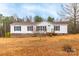 Charming one-story home featuring a cozy front porch and well-maintained landscaping on a large lot at 1912 Beach Ln, Heath Springs, SC 29058