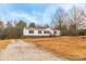 Inviting one-story home with a well-manicured lawn and a convenient gravel driveway on a large lot at 1912 Beach Ln, Heath Springs, SC 29058