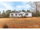 Charming single story home nestled on a serene lot, featuring a welcoming entrance and a cozy, inviting atmosphere at 1912 Beach Ln, Heath Springs, SC 29058