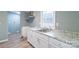 Kitchen featuring white cabinets, granite counters, a sink and modern appliances at 1912 Beach Ln, Heath Springs, SC 29058