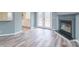 Living room with updated flooring, gray fireplace, and bright natural light at 1912 Beach Ln, Heath Springs, SC 29058