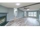 Bright and airy living room with a fireplace, ceiling fan, and modern flooring, seamlessly connecting to other spaces at 1912 Beach Ln, Heath Springs, SC 29058