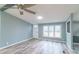 Bright living room features modern flooring, a ceiling fan, and a welcoming ambiance with ample natural light at 1912 Beach Ln, Heath Springs, SC 29058