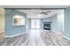 Open living room with fireplace, ceiling fan, gray walls, and patio doors at 1912 Beach Ln, Heath Springs, SC 29058