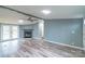 Inviting living room featuring a cozy fireplace, stylish flooring, and abundant natural light from the french doors at 1912 Beach Ln, Heath Springs, SC 29058