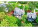 Aerial view of a blue house with a backyard patio, pool, and a lush green lawn at 208 Cape August Pl, Belmont, NC 28012