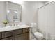 Clean bathroom with a vanity, a large mirror, and a white shower curtain at 208 Cape August Pl, Belmont, NC 28012