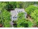 Charming blue home with a well-manicured lawn and mature trees surrounding the property at 208 Cape August Pl, Belmont, NC 28012