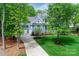 Inviting blue home with a well-maintained lawn, a long driveway, and a two-car garage at 208 Cape August Pl, Belmont, NC 28012