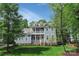 Charming two-story home features a double balcony, yellow front door, and well-manicured lawn at 208 Cape August Pl, Belmont, NC 28012