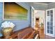 Elegant hallway featuring beautiful wainscoting, artwork, and hardwood floors at 208 Cape August Pl, Belmont, NC 28012