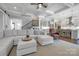 Inviting living room with a coffered ceiling flowing into a modern kitchen at 208 Cape August Pl, Belmont, NC 28012