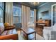 Sitting room featuring a piano, large windows, and comfortable seating at 208 Cape August Pl, Belmont, NC 28012