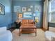 Cozy office with blue walls, hardwood floors, a brown leather couch, and natural light at 208 Cape August Pl, Belmont, NC 28012