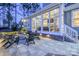 Outdoor patio featuring a fire pit, comfortable seating, and backyard access at 208 Cape August Pl, Belmont, NC 28012