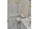 Well-lit bathroom with a shower-tub combo, tile flooring, modern toilet and sink at 215 Creek View Rd, Mooresville, NC 28117