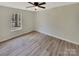 Simple bedroom featuring wood-look flooring and a large window offering natural light at 215 Creek View Rd, Mooresville, NC 28117