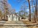 Charming single-story home with an attached two-car garage and a long driveway surrounded by trees at 215 Creek View Rd, Mooresville, NC 28117