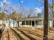 Home featuring a garage, welcoming front porch, and well-maintained landscaping at 215 Creek View Rd, Mooresville, NC 28117