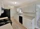 Functional kitchen featuring white cabinets, modern appliances, and neutral countertops at 215 Creek View Rd, Mooresville, NC 28117