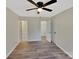 Main bedroom featuring a ceiling fan, modern floors, and ensuite bathroom access at 215 Creek View Rd, Mooresville, NC 28117