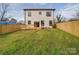 Large, green backyard with a wooden fence, ideal for outdoor activities, and a well-maintained wooden deck at 2511 Dundeen St, Charlotte, NC 28216