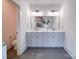 Spacious bathroom features double sinks with gray cabinets and modern lighting at 2511 Dundeen St, Charlotte, NC 28216