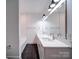 Stylish bathroom with dual sinks, sleek fixtures, a large mirror, and modern lighting at 2511 Dundeen St, Charlotte, NC 28216