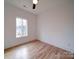 Bright bedroom featuring a large window and hardwood floors overlooking the outdoors at 2511 Dundeen St, Charlotte, NC 28216