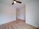 Spacious bedroom with hardwood floors, ceiling fan, and plenty of natural light at 2511 Dundeen St, Charlotte, NC 28216