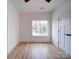 Well-lit bedroom with a large window and hardwood floors offering comfort at 2511 Dundeen St, Charlotte, NC 28216