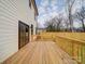 Spacious wooden deck with railing, perfect for outdoor relaxation and entertaining with sliding door access to inside at 2511 Dundeen St, Charlotte, NC 28216