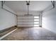 Clean, spacious garage with overhead door and ample room for parking and storage with bright natural light at 2511 Dundeen St, Charlotte, NC 28216